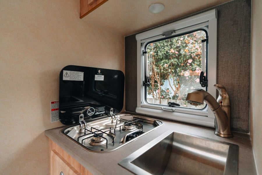 Camper kitchen with gas stove and sink