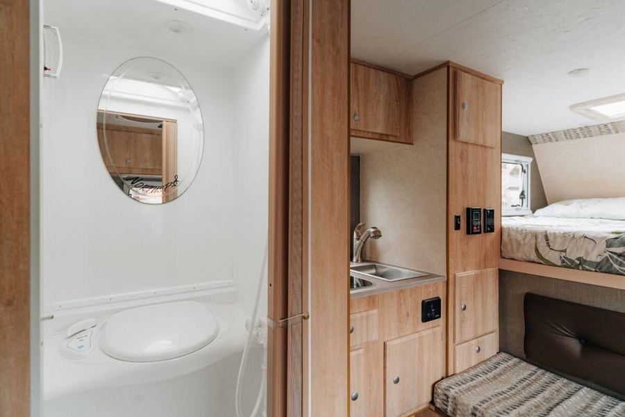 Enclosed shower and toilet beside the kitchen