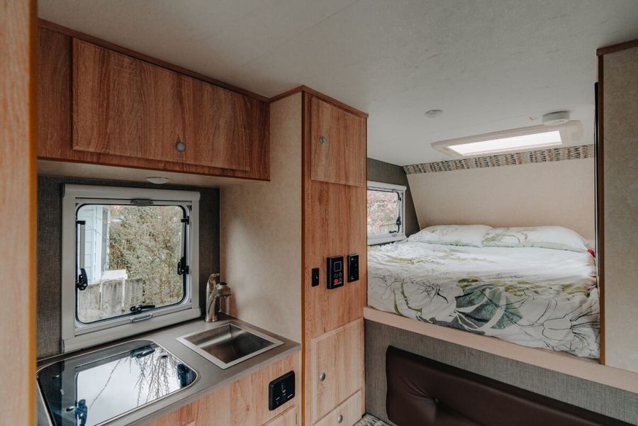 Overhead cupboards above the dinette and bed