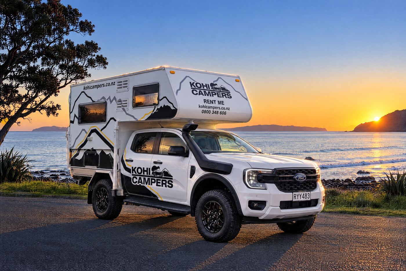 Kohi 4x4 Camper at sunrise beside a bay